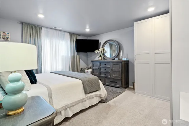 a bedroom with a bed and a television