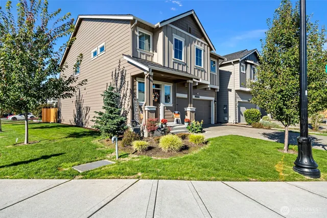 a front view of a house with garden and porch