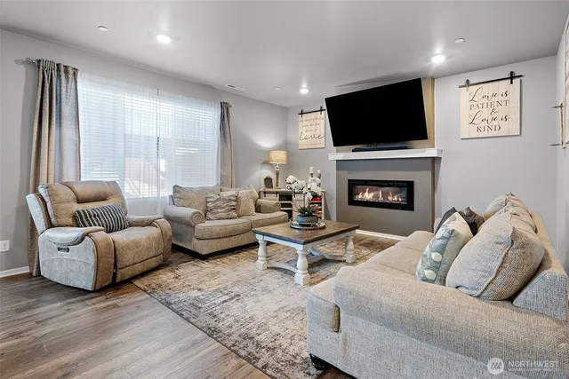 a living room with furniture flat screen tv and a fireplace
