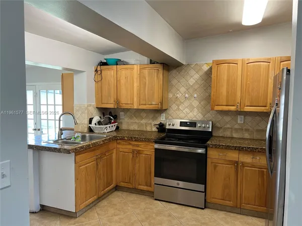 a kitchen with refrigerator and window