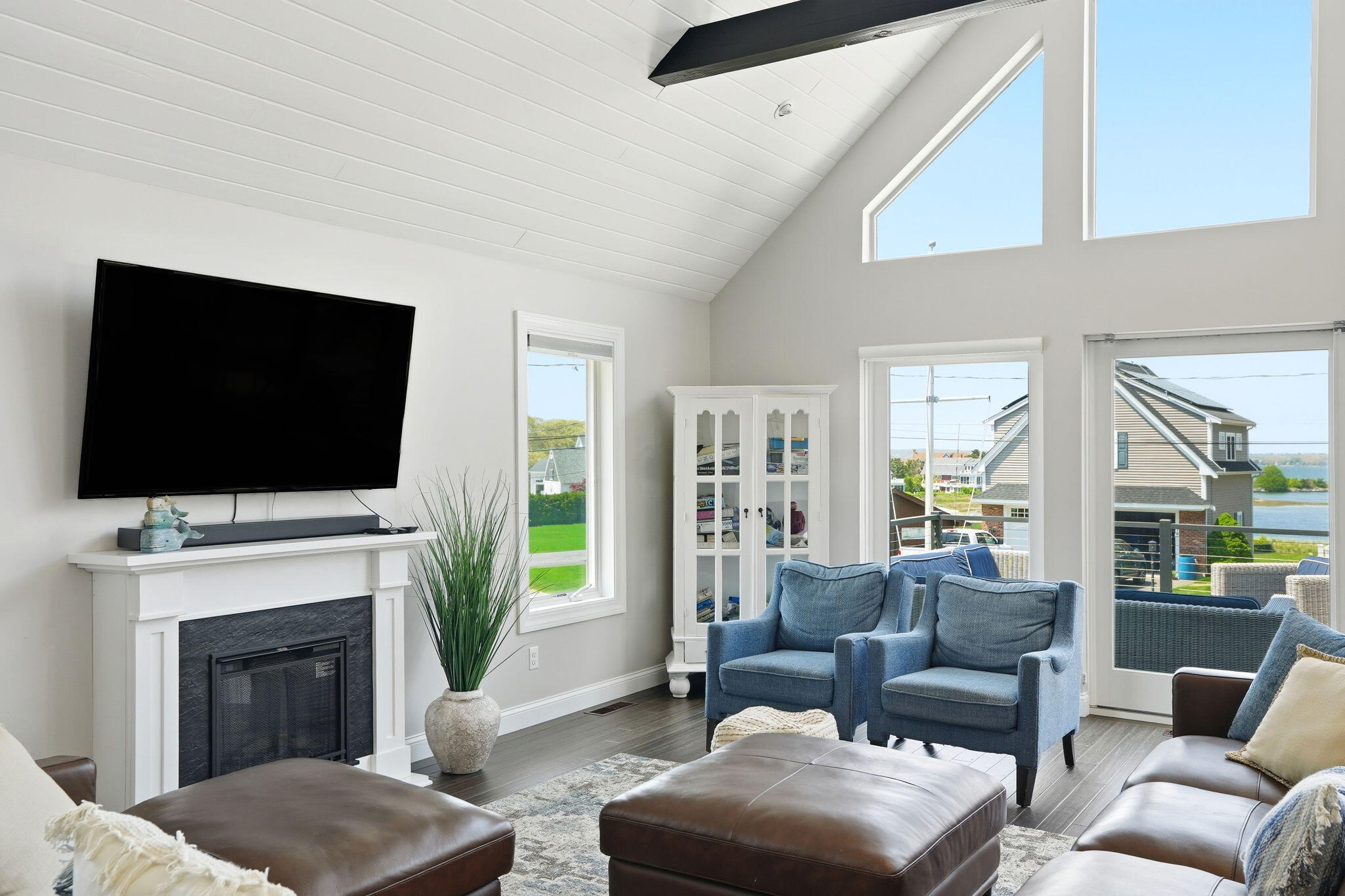 4 Cross Road Bourne, MA 02532 - Photo 13 of 47 a living room with furniture a flat screen tv and a fireplace