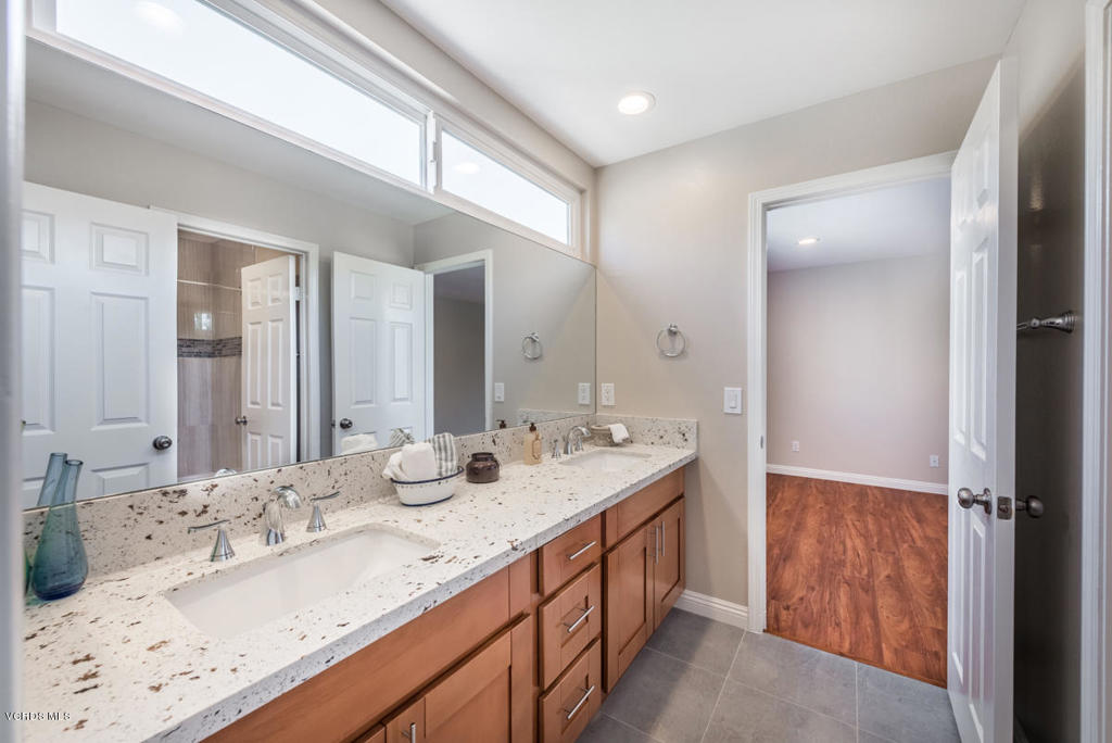 3403 Fayance Place Thousand Oaks, CA 91362 - Photo 21 of 23 a bathroom with double vanity sinks and a mirror