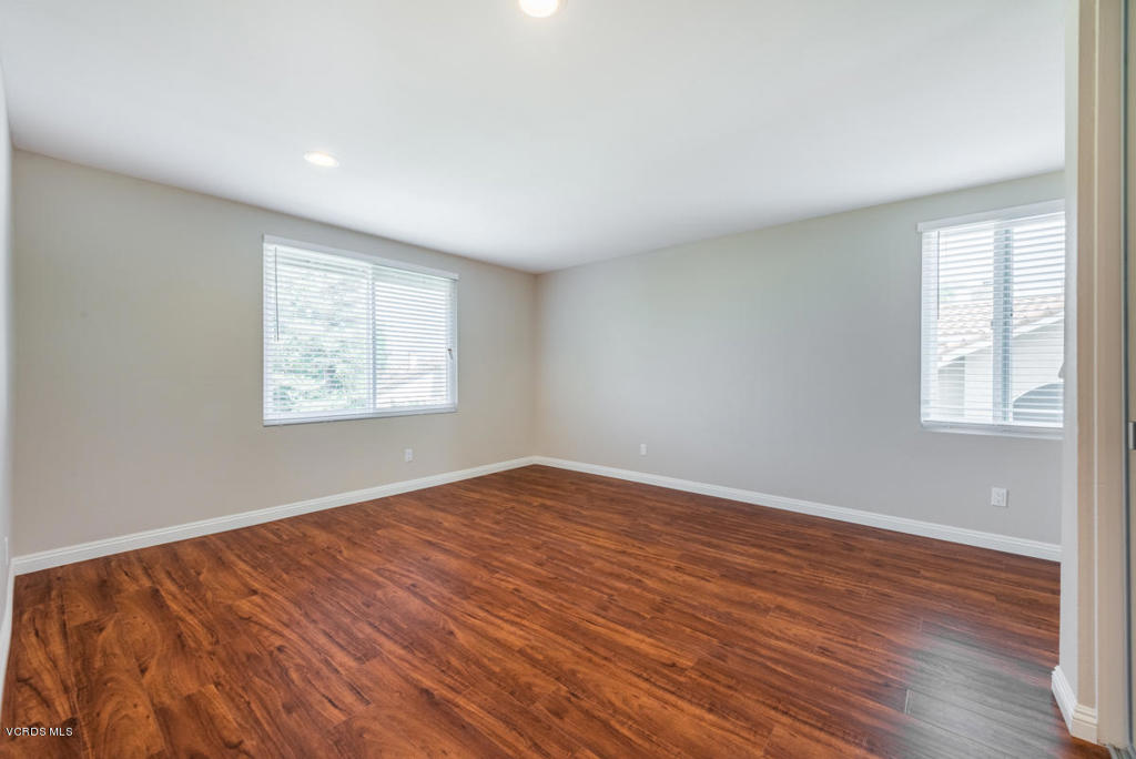 3403 Fayance Place Thousand Oaks, CA 91362 - Photo 22 of 23 an empty room with wooden floor and windows