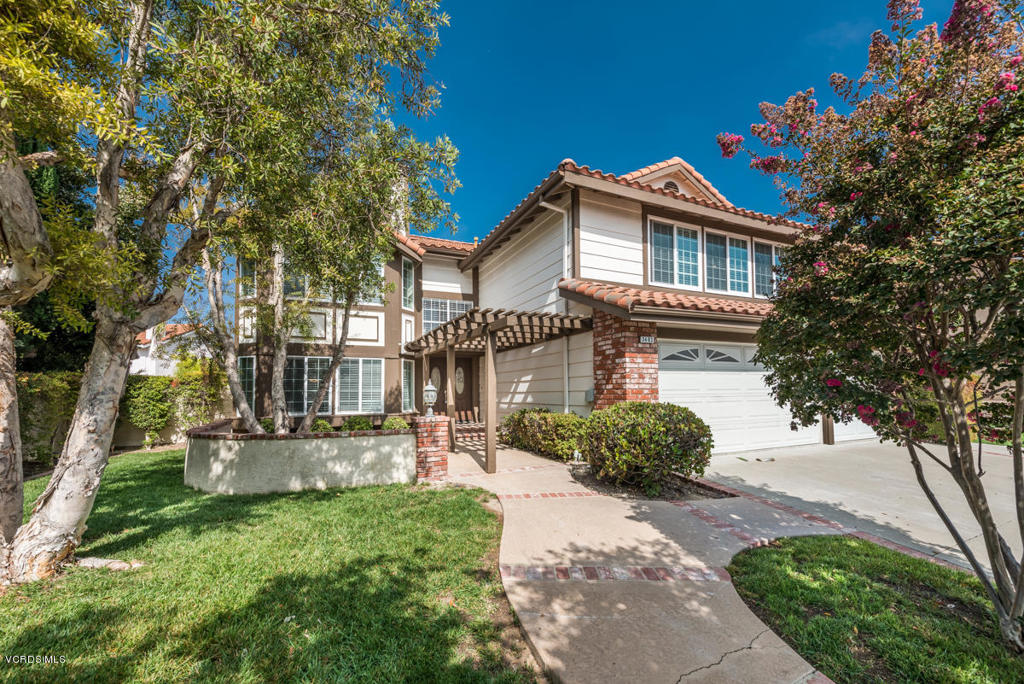 3403 Fayance Place Thousand Oaks, CA 91362 - Photo 8 of 23 a front view of a house with a yard and garage