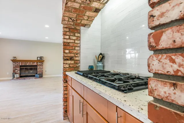 a kitchen with stainless steel appliances granite countertop a stove and a wooden cabinets