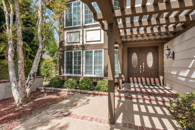 a front view of a building with a garden