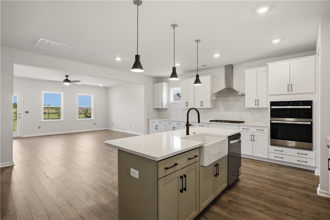 552 Hydrangea Street, Unit LOT 66 Seneca, SC 29678 - Photo 7 of 31 An open-concept design connects a modern kitchen with a spacious living area, ideal for gathering.