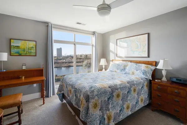 a living room with furniture a flat screen tv and a large window