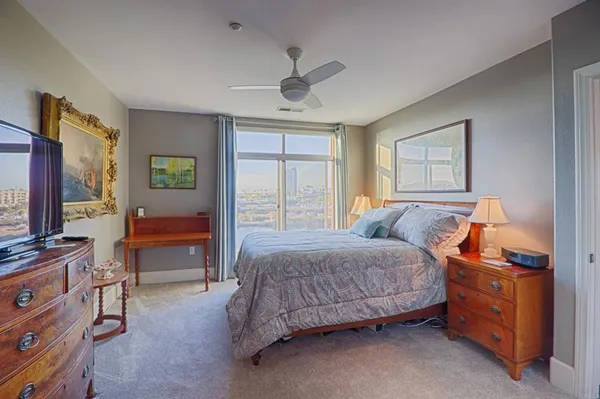 a bathroom with a granite countertop double vanity sink a mirror and a shower