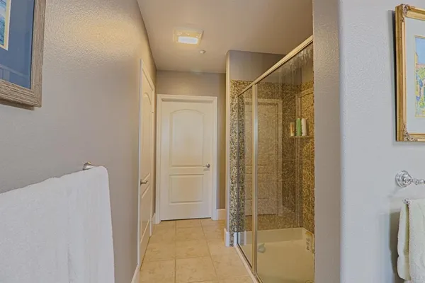 a spacious bathroom with a granite countertop sink mirror and shower