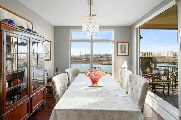 a living room with furniture wooden floor and a large window