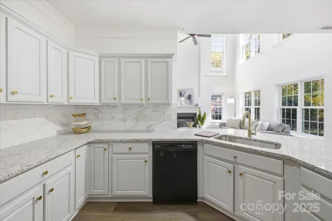 a kitchen with granite countertop white cabinets and white appliances