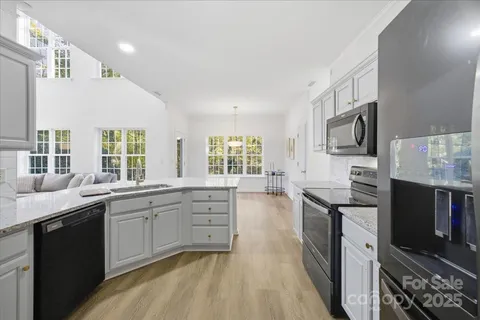 a kitchen with stainless steel appliances sink stove microwave and cabinets