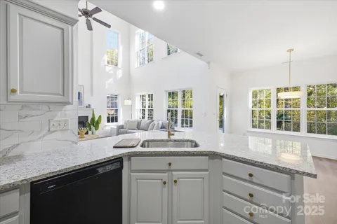 a kitchen with granite countertop a sink and a window