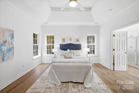 a bedroom with a large bed and a chandelier