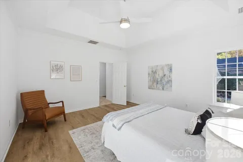 a bedroom with a bed and a chair