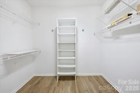 a view of walk in closet with empty racks