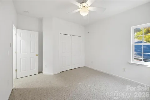 an empty room with windows and closet