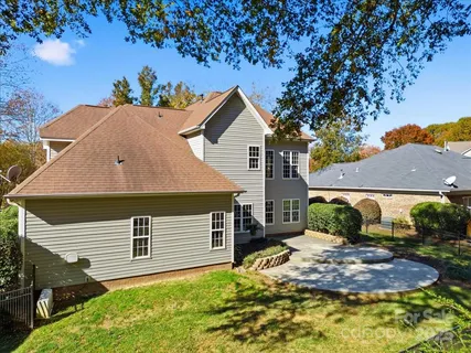 a aerial view of a house with a yard and large tree