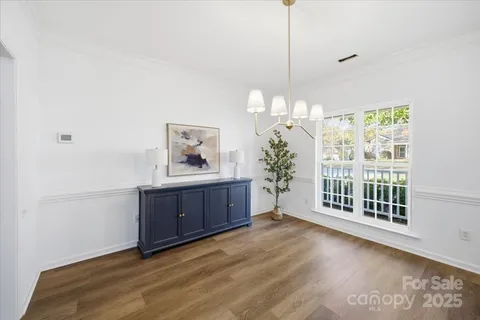 a view of a room with a window and wooden floor