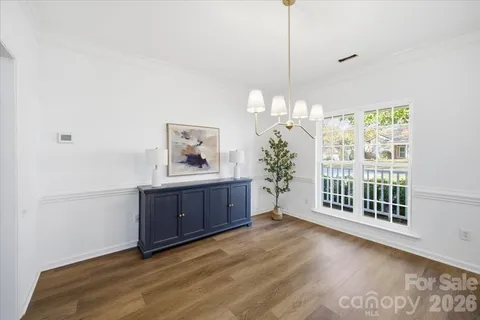 a view of a room with a window and wooden floor