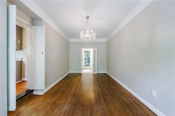 a view of an empty room with a fireplace and a window