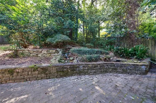 a view of a backyard with large trees