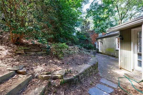 a view of an house with backyard space and sitting area