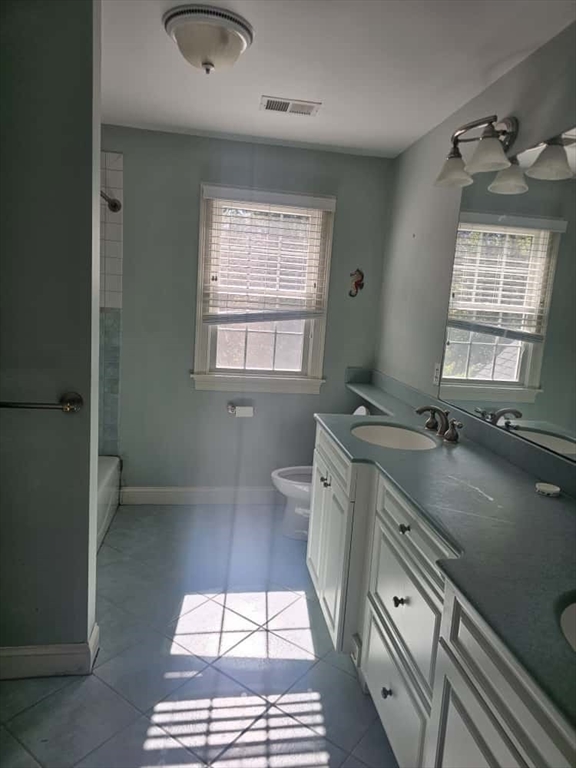 4 Shoe String Lane Westwood, MA 02090 - Photo 21 of 28 a bathroom with a sink a toilet a mirror and window