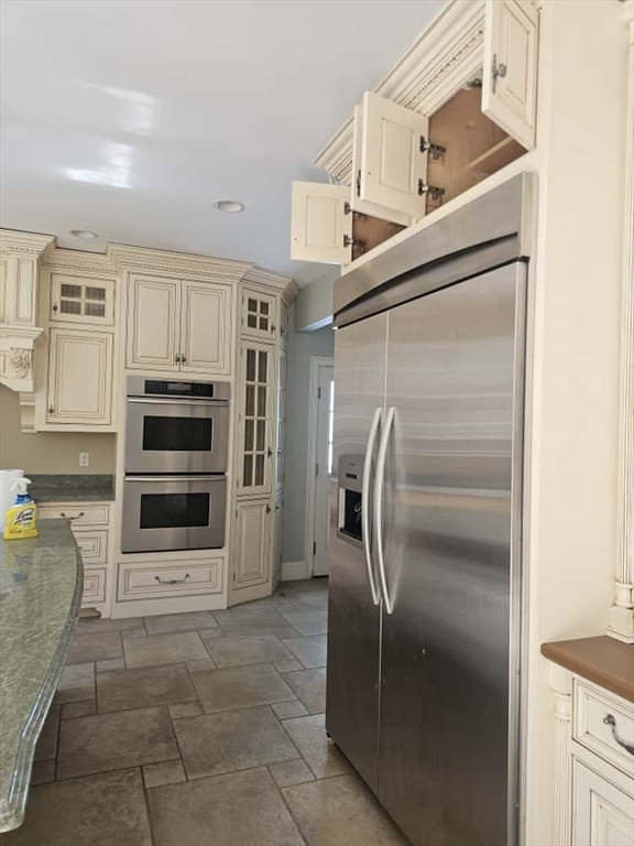 4 Shoe String Lane Westwood, MA 02090 - Photo 9 of 28 a kitchen with stainless steel appliances kitchen island granite countertop a refrigerator and cabinets