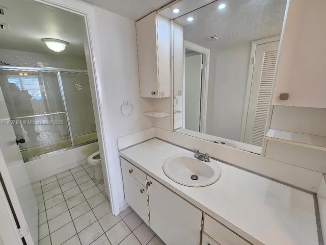a bathroom with a sink a mirror and a shower