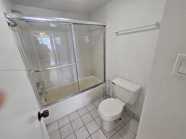 a bathroom with a shower a toilet and sink