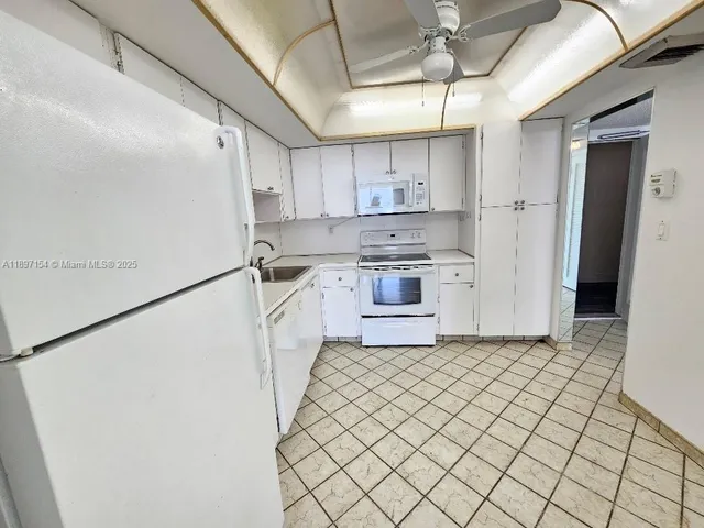 a kitchen with stainless steel appliances a refrigerator sink and cabinets
