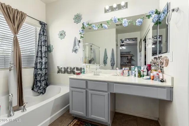 a bathroom with a bathtub a sink and mirror