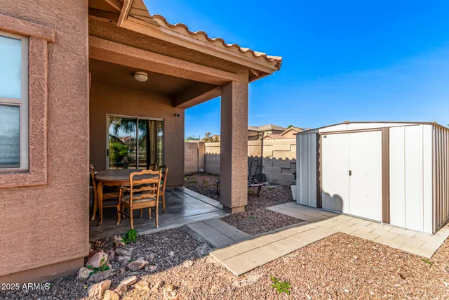 a view of a chairs and table in front of a house