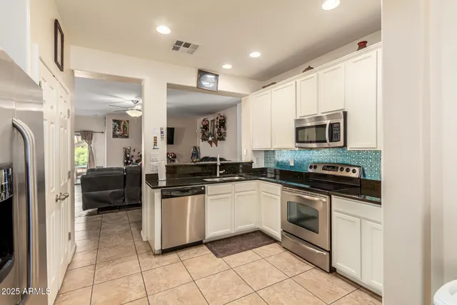 a kitchen with stainless steel appliances a stove a sink and a refrigerator