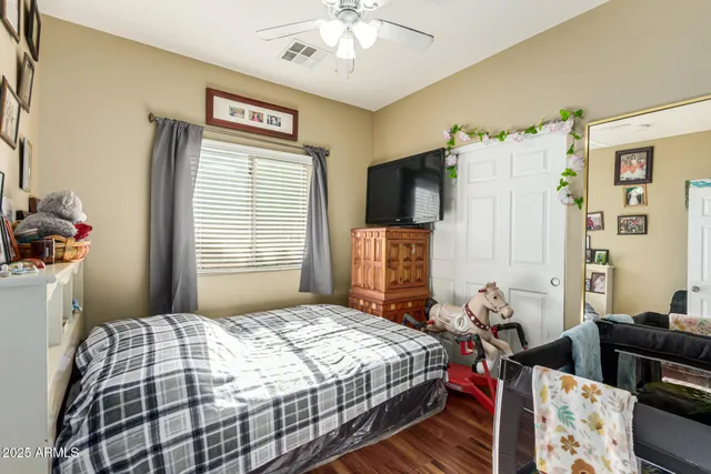 a bedroom with a bed and a chandelier