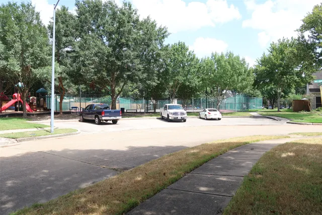 a view of street with parked cars