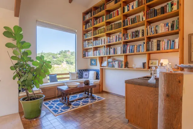 a view of a livingroom with furniture and staircase
