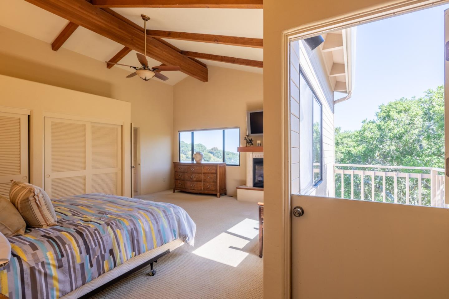 25940 Colt Lane Carmel Valley, CA 93924 - Photo 24 of 40 a bedroom with a bed a couch and dresser