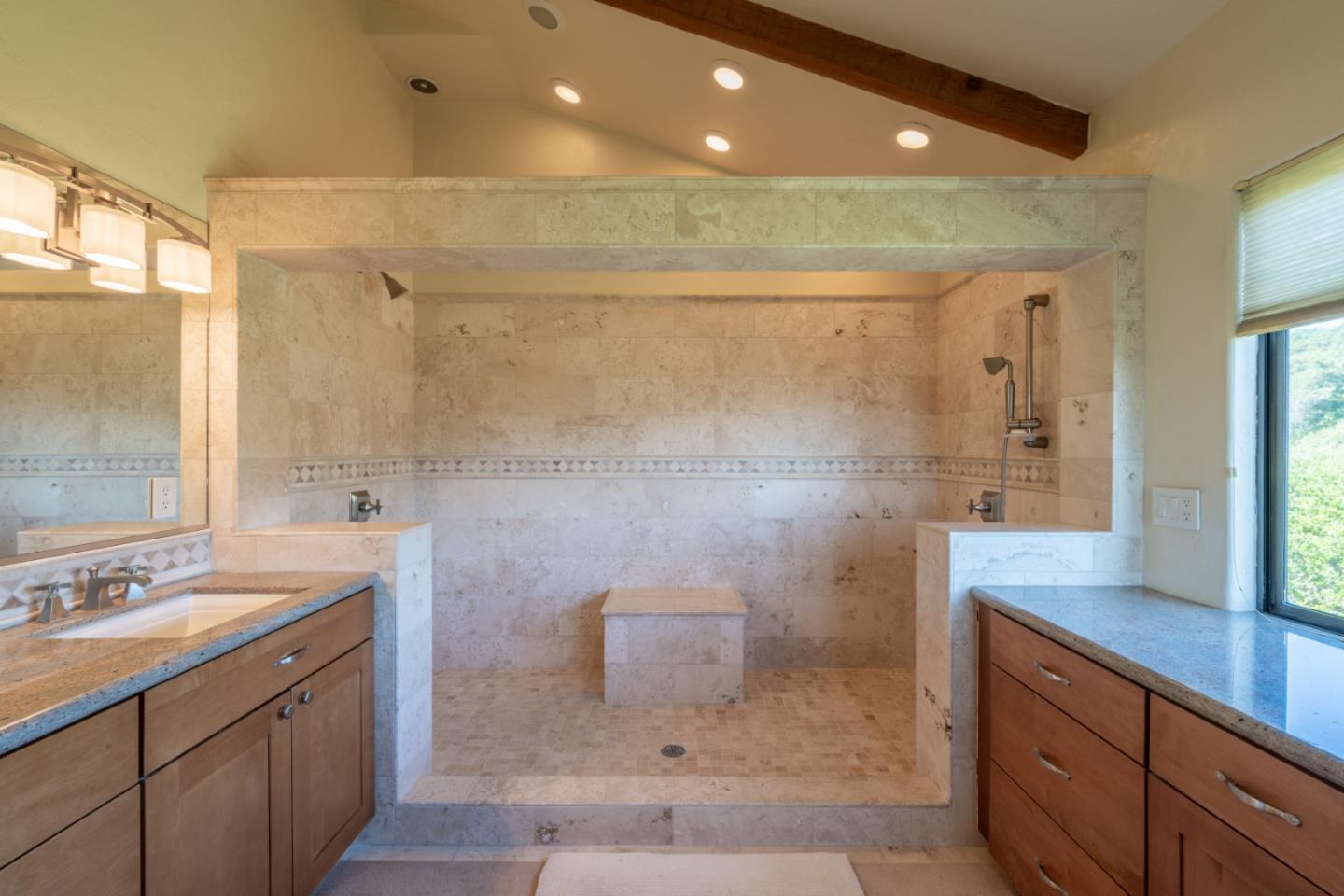 25940 Colt Lane Carmel Valley, CA 93924 - Photo 28 of 40 a bathroom with a granite countertop sink a mirror and shower
