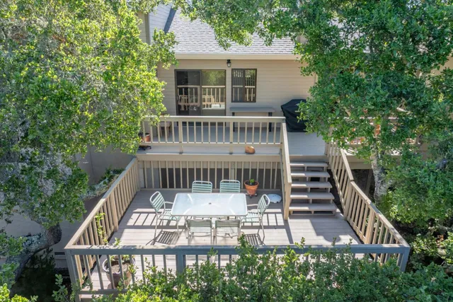 a view of a deck with two chair and wooden floor
