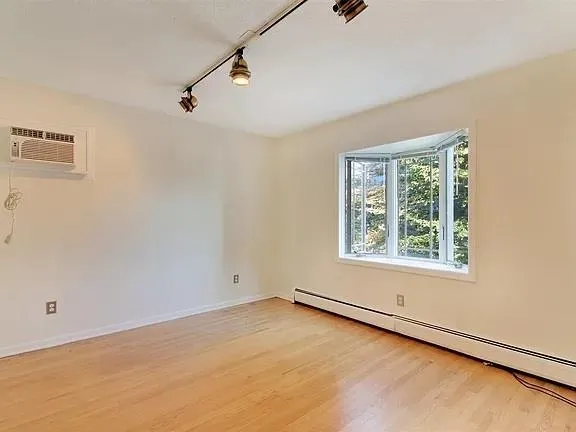 a spacious bathroom with a double vanity sink a mirror and a toilet