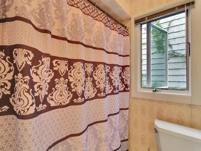 a front view of a house with a parking space