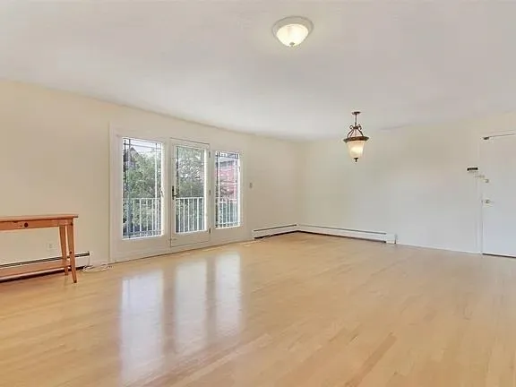 wooden floor in an empty room with a window