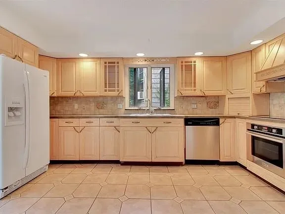 a kitchen with granite countertop white cabinets and white appliances