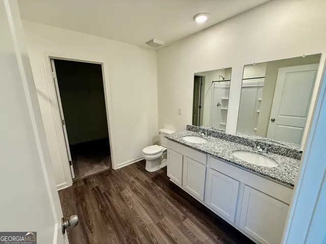 a bathroom with a granite countertop shower toilet and sink