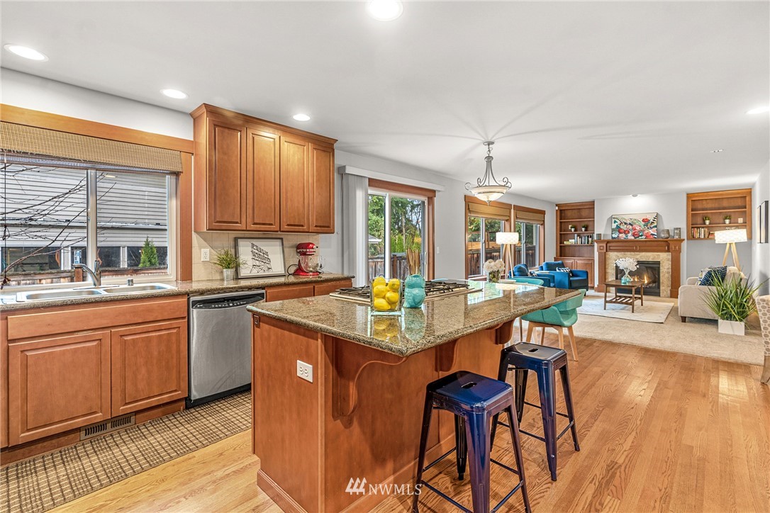 22424 6th Place West Bothell, WA 98021 - Photo 9 of 31 a kitchen with stainless steel appliances granite countertop a table chairs and a wooden floors