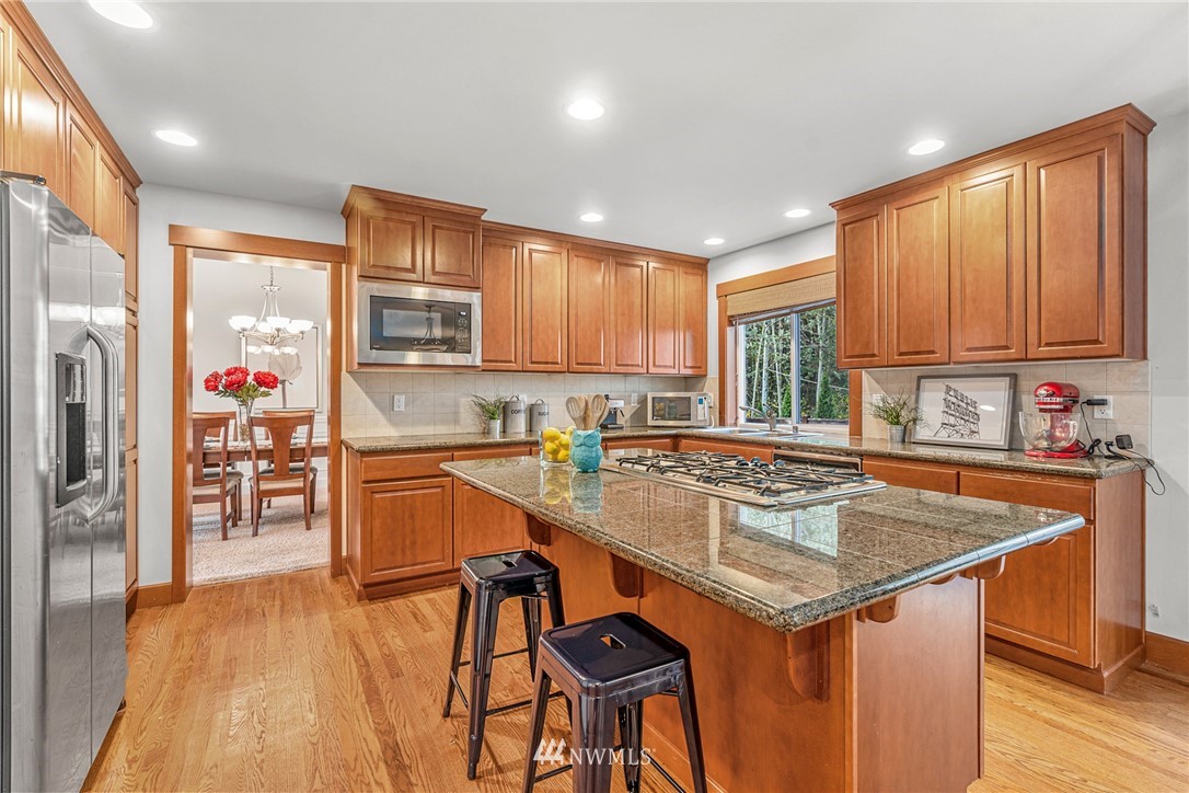 22424 6th Place West Bothell, WA 98021 - Photo 10 of 31 a kitchen with stainless steel appliances granite countertop a sink stove and refrigerator