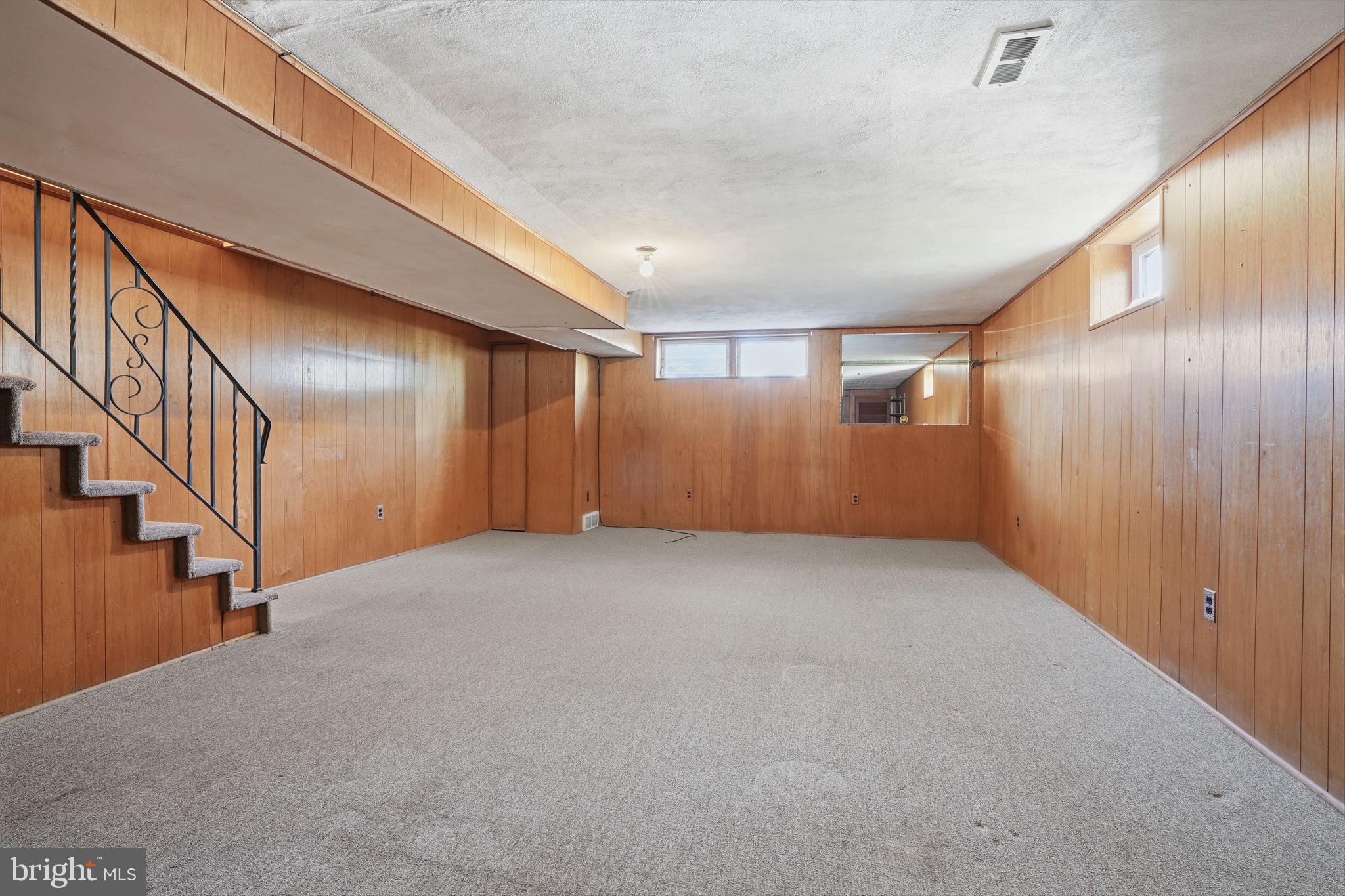 2035 Nester Street Philadelphia, PA 19115 - Photo 16 of 27 Spacious basement with warm wood paneling.